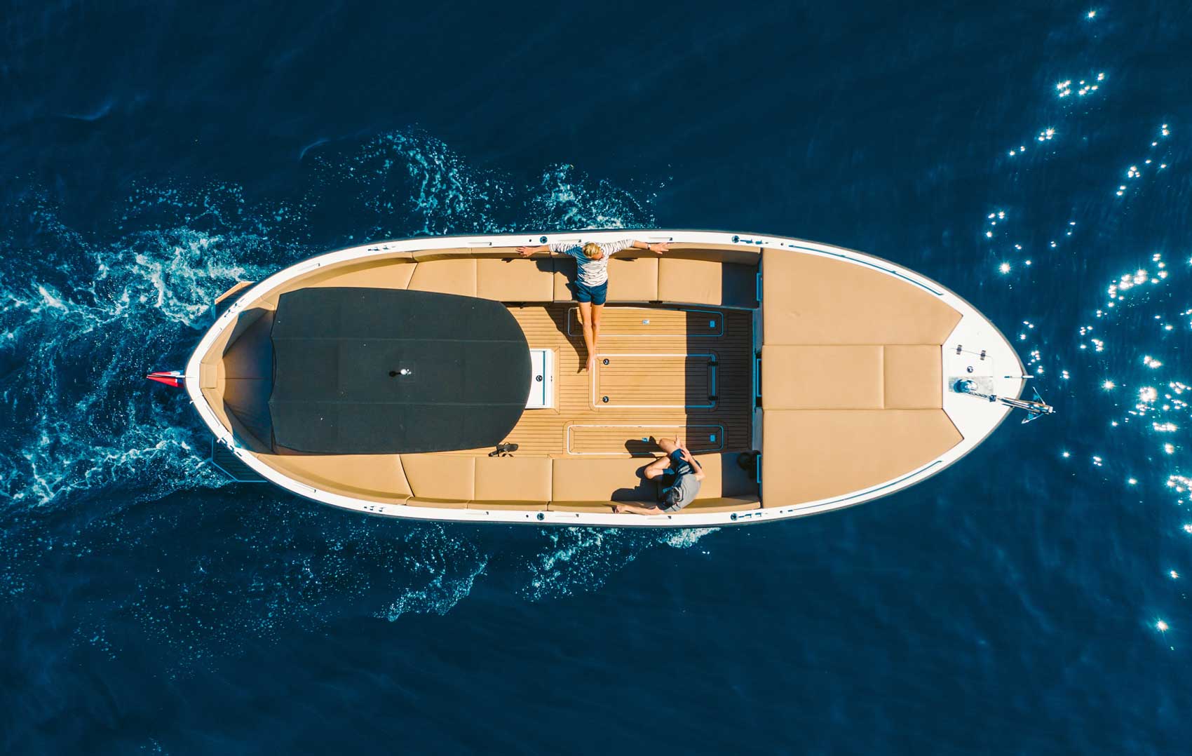 Overhead view of a boat with two passengers on the water