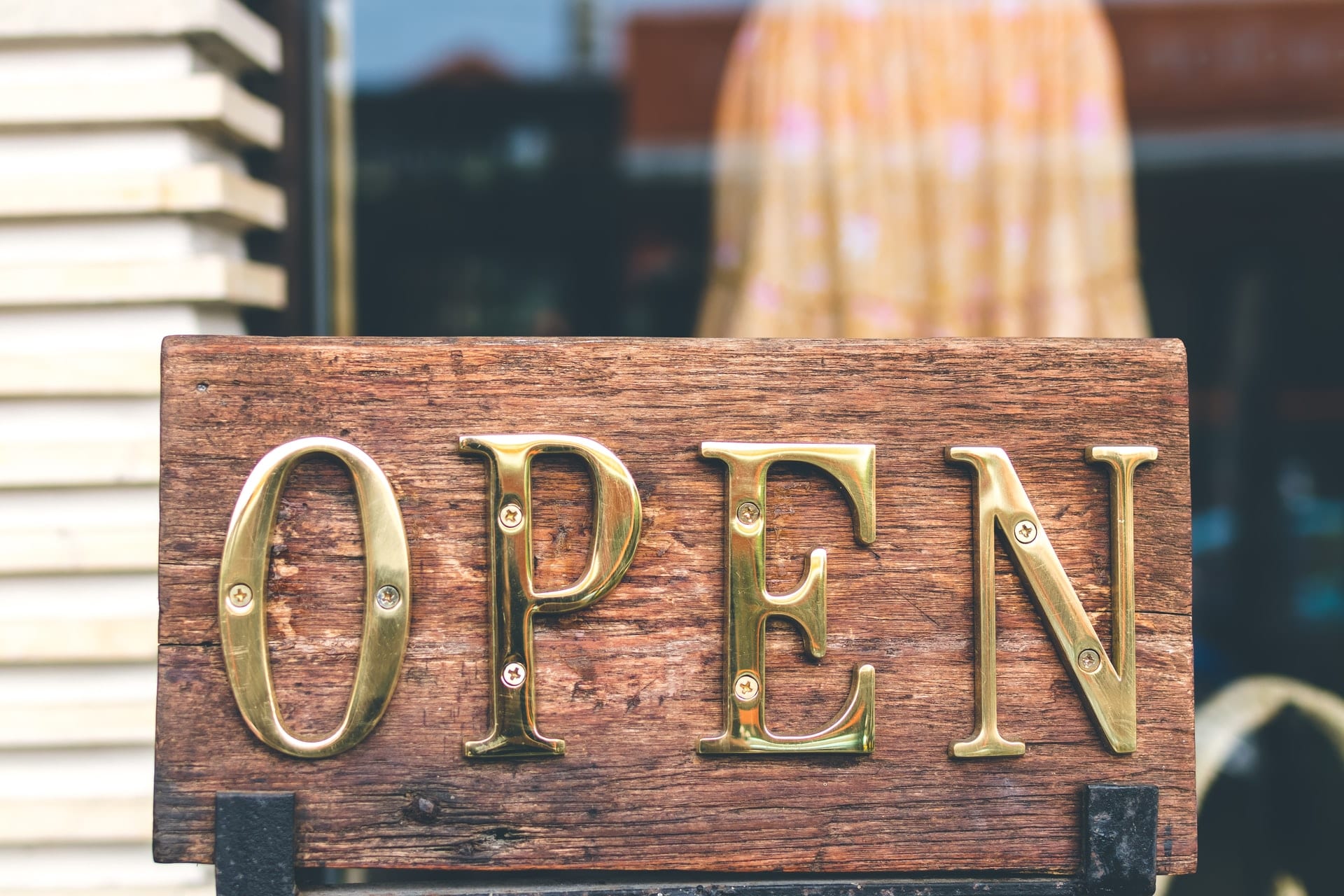 Wooden sign that reads "Open"