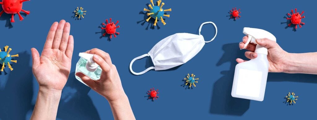 Hands washing, a spray bottle and a mask all with virus imitations in the background.